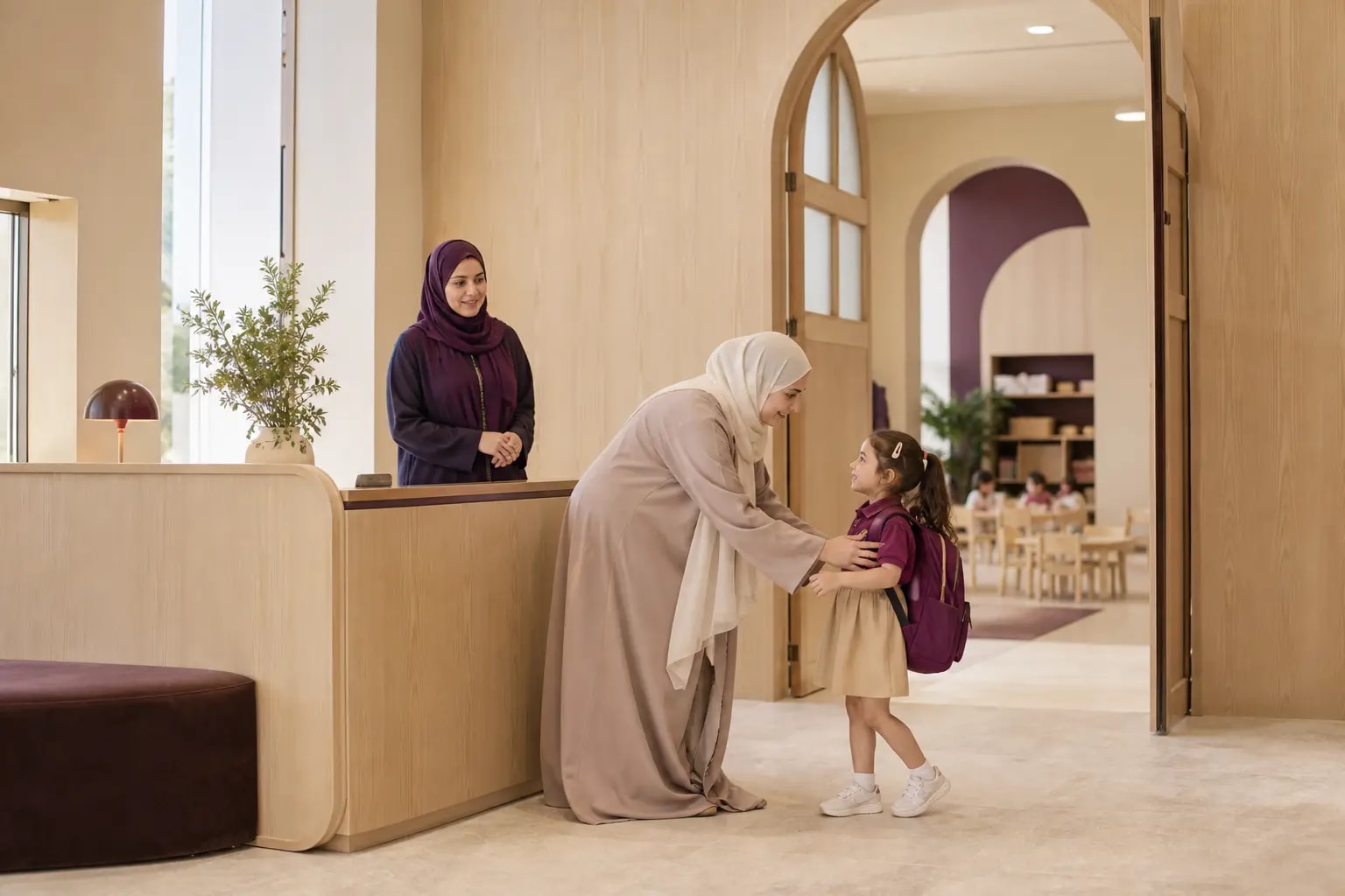 Calm morning handover between a family, reception colleague and early-years educator at a nursery entrance